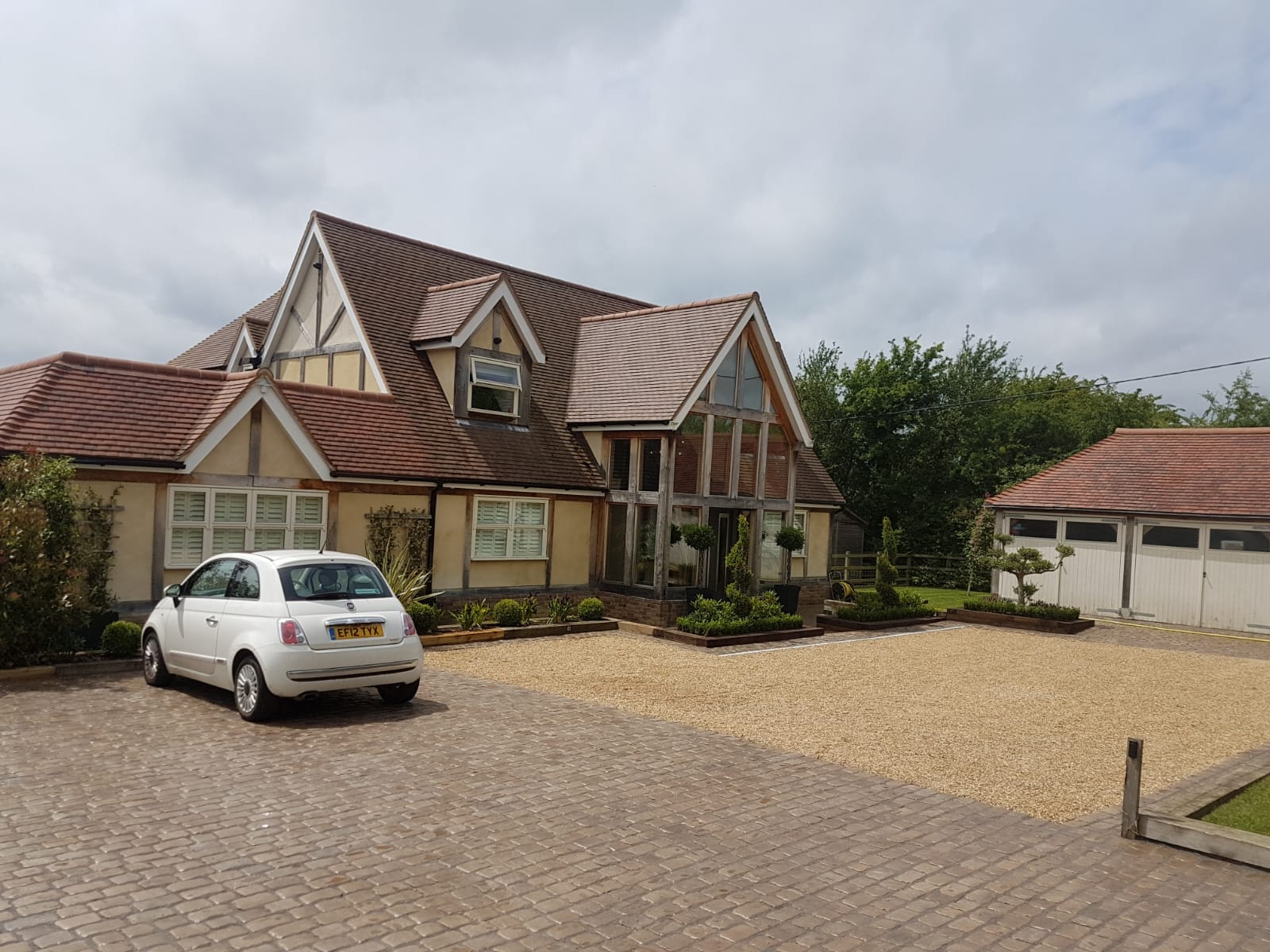 An image showing a block paving driveway with gravel