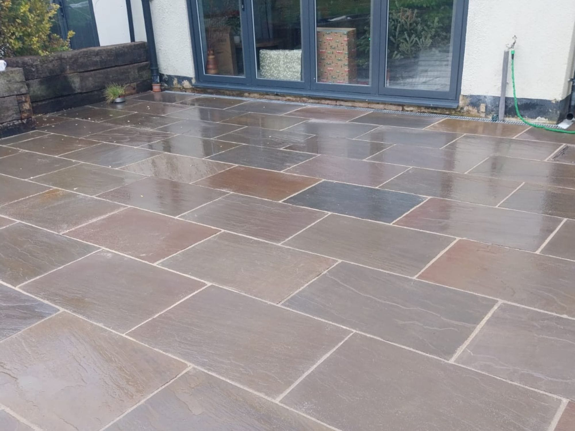 An image showing a new patio installed with a grey tone.